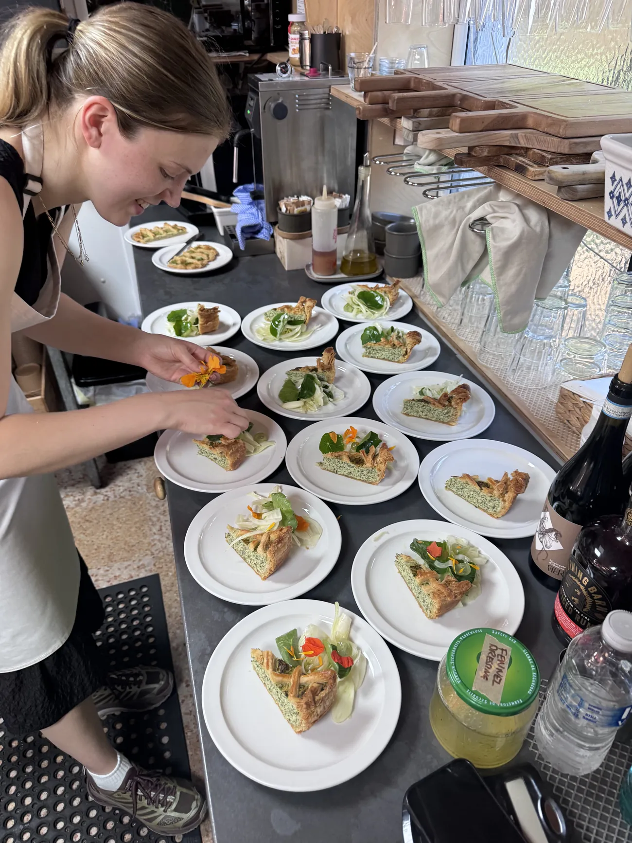 Emma plating the Torta Rustica with fennel and nasturtium salad