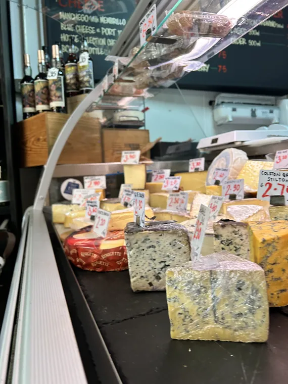 Inside the cheese fridge with assorted cheeses