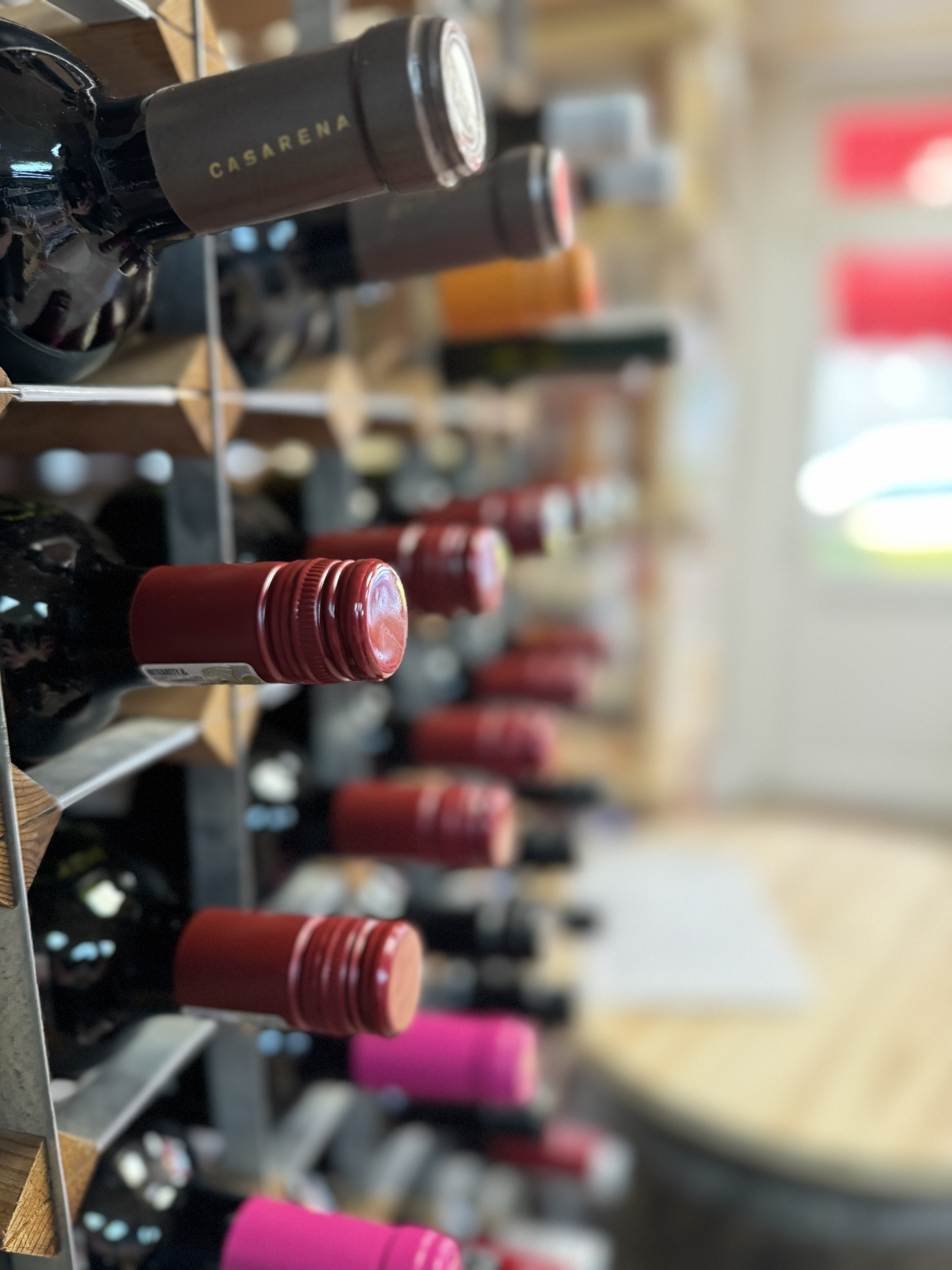 Wine shelf with red wine on left, white wine on right